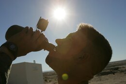 Pfc. Jesse Lande, 20, an ammunition tech with Weapons Company, 3/3, and a native Of Menomonie, Wis., hydrates before going on patrol in the Twentynine Palms sun.