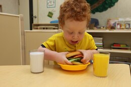 Scotty Howard, a 2-year-old in the Toddler 1 classroom at the new Hadnot Point Child Development Center plays with his pretend burger. Howard is training to be the next "Iron-Chef."
