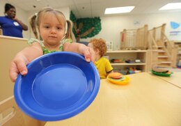 Madison Martin, a 2-year-old in the Toddler 1 Classroom at the new Hadnot Point Child Development Center holds out her magic cakes. ::r::::n::