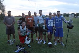 Members in the Lejeune Lacrosse Club take a moment to pose after practice near the steam plant on W.P.T. Hill Field, aboard Marine Corps Base Camp Lejeune, Oct. 18. The team has opened its arms to personnel aboard the base, who are interested in playing the intense sport, regardless of prior lacrosse experience.