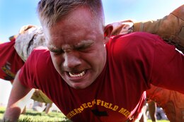 Cpl. Duncan C. Reidner, separations clerk, Disbursing Company, Combat Logistics Regiment-17, 1st Marine Logistics Group, pushes himself to the limit while doing fire-team pushups during Camp Pendleton’s 2010 Leatherneck Field Meet at the 11 Area field, Oct. 27. The Leatherneck Field Meet is a competition for Marines to compete against other units to build camaraderie and esprit de corps.