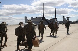 Marines from Landing Support Company, Combat Logistics Regiment 17, 1st Marine Logistics Group, grab their gear and load up on a V-22 Osprey, Feb. 17. The Marines are getting ready for a helicopter support team training exercise.