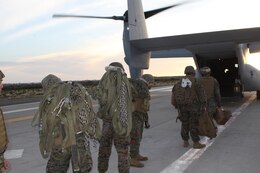 Marines from Landing Support Company, Combat Logistics Regiment 17, 1st Marine Logistics Group, grab their gear and load up on a V-22 Osprey, Feb. 17. The Marines are packing up from their helicopter support team training exercise.
