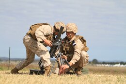 U.S. Marine Corps Lance Cpl. Craig J. Reyes (left) and Cpl. Caleb D. Benson (right), mortarmen with Golf Company, Battalion Landing Team 2nd Battalion 7th Marines, 31st Marine Expeditionary Unit, conduct a weapons drill with a mortar on Camp Rocky during Talisman Saber 2011. TS11 is a biennial combined training activity, designed to train Australian and U.S. forces in planning and conducting Combined Task Force operations to improve Australian Defense Force/U.S. combat readiness and interoperability. It reflects the closeness of the alliance and the strength and flexibility of the ongoing military-military relationship.