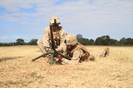 U.S. Marine Corps Lance Cpls. Chris L. Kusnierz (left) and Jonathon P. Ashley (right), machinegunners with Weapons Company, Battalion Landing Team 2nd Battalion 7th Marines, 31st Marine Expeditionary Unit, conduct a weapons drill with a .50 caliber machine gun on Camp Rocky during Talisman Saber 2011. TS11 is a biennial combined training activity, designed to train Australian and U.S. forces in planning and conducting Combined Task Force operations to improve Australian Defense Force/U.S. combat readiness and interoperability. It reflects the closeness of the alliance and the strength and flexibility of the ongoing military-military relationship.