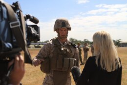Anna McManamey, a newsreporter for Australian News Channel 7, interviews Cpl. Caleb D. Benson, a mortarman with Golf Company, Battalion Landing Team 2nd Battalion 7th Marines, 31st Marine Expeditionary Unit, after a weapons drill on Camp Rocky during Talisman Saber 2011. TS11 is a biennial combined training activity, designed to train Australian and U.S. forces in planning and conducting Combined Task Force operations to improve Australian Defense Force/U.S. combat readiness and interoperability. It reflects the closeness of the alliance and the strength and flexibility of the ongoing military-military relationship.