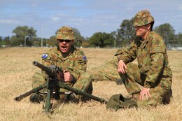 Australian Defense Force Craftsman Carl Norling (left), armorer, 6th Aviation Regiment, and Privates Peter Noble (center) and James Newton (right), operator supply, 6th Aviation Regiment, conduct a weapons drill with a U.S. .50 caliber machine gun on Camp Rocky during Talisman Saber 2011. TS11 is biennial combined training activity, designed to train Australian and U.S. forces in planning and conducting Combined Task Force operations to improve Australian Defense Force/U.S. combat readiness and interoperability. It reflects the closeness of the alliance and the strength and flexibility of the ongoing military-military relationship.