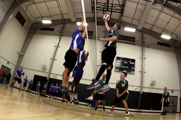 A member of the Supply Battalion 'Dragons 1' prepares to spike the ball during the 2011 USAA Pendleton Cup Intramural Volleyball League at Camp Pendleton’s 33-Area gym, Sept. 21. The units that participate are awarded points toward the Pendleton Cup competition, and the winning teams are selected for higher for playoffs that are scheduled at the end of October.