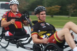 A double amputee operates hand pedals on a tandem cycle with his partner during the Wounded Warrior cycling camp held aboard Camp Geiger, Sept. 27 through 29.