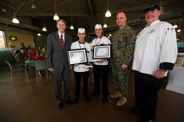 The winners of both the People's Choice and overall titles, Cpl. John Lucido and Sgt. Sean Dodds of the 1st Marine Headquarters Expeditionary Force Group field mess, stand with distinguished guests at the 41-Area Mess Hall here, during the first fiscal year 2013 Chef of the Quarter Competition Dec. 5.