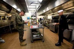 Cpl. John Lucido from 1st Marine Headquarters Expeditionary Group field mess is scored on his preparation and cleanliness during the first fiscal year 2013 Chef of the Quarter Competition at the 41-Area Mess Hall here Dec. 5. During the competition, Marines and Sodexo cooks got judged on not only their cooking, but their knowledge of the kitchen.