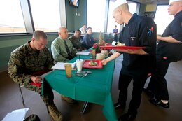 Cpl. John Lucido and Sgt. Sean Dodds, both from 1st Marine Headquarters Expeditionary Group field mess, present their final dishes to the judges during the first fiscal year 2013 Chef of the Quarter Competition at the 41-Area Mess Hall here Dec. 5. Lucido and Dodds took home both the People's Choice and overall awards for the competition and will be attending a 2-month-long course at the Culinary Institute of America in New York.