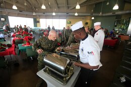 Gunnery Sgt. James Horak, the 3rd Light Armored Reconaissance mess chief, samples food during the first fiscal year 2013 Chef of the Quarter Competition a the 41-Area Mess Hall here Dec. 5. Distinguished guests attended the event to choose a People's Choice Award from the four final teams competing.
