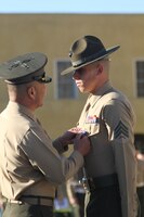 Brig. Gen. Daniel D. Yoo, commanding general, Marine Corps Recruit Depot San Diego and the Western Recruiting Region, pins a Silver Star on Sgt. Phillip A. McCulloch Jr., drill instructor, Company M, 3rd Recruit Training Battalion, during the morning colors ceremony aboard MCRD Feb 10. McCulloch was awarded the medal for his actions during a six-hour engagement with insurgent forces in the Sangin District in support of Operation Enduring Freedom Jan. 8, 2011.