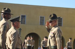 Sgt. Phillip A. McCulloch Jr., drill instructor, Company M, 3rd Recruit Training Battalion, salutes Brig. Gen. Daniel D. Yoo, commanding general, Marine Corps Recruit Depot San Diego and the Western Recruiting Region, after receiving a Silver Star during the morning colors ceremony aboard MCRD Feb 10. McCulloch was awarded the medal for his actions during a six-hour engagement with insurgent forces in the Sangin District in support of Operation Enduring Freedom Jan. 8, 2011.