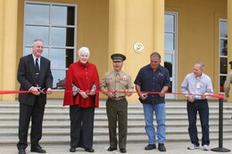 From left to right, Mike Nelson, Sabina Pendleton McDougal Neal, Brig. Gen. Daniel D. Yoo, commanding general, Marine Corps Recruit Depot San Diego and the Western Recruiting Region, Oscar Villafranca, president, Dimension Construction, and Joe Koppel, engineer tech, facilities, get ready to cut the ribbon for the rededication ceremony of McDougal Hall aboard MCRD San Diego Feb. 27. Neal and Nelson are family members of Maj. Gen. Douglas McDougal, who the base theater is named after.