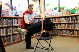 Amazing Dana the Nutrition Magician performs a levitating trick for children enrolled in Camp Pendleton’s summer reading club at the base’s Patrick J. Carney Library, June 20. This is the third year in which 250 base and installation libraries will participate in the summer reading program developed by the Department of Defense.