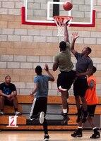 Pfc. Harrison Ashong, a warehouse cleric for 1st Supply Battalion, takes a shot during a basketball tournament at Paige Field house Oct. 31.