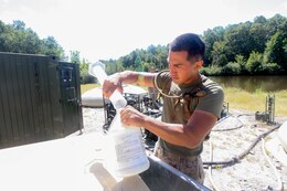 Lance Cpl. Eric D. Rivera, a Houston, Texas, native, water purification specialist assigned to Combat Logistics Battalion (CLB) 26, 26th Marine Expeditionary Unit (MEU), tests the chlorine levels in the battalions new lightweight water purification system at Fort Pickett, Va., Sept. 10, 2012. This is the first time the battalion has fielded the purification system, which can pump water from a local water source and filter 450 gallons per hour of clean drinking water. This training is part of the 26th MEU's pre-deployment training program. CLB-26 is one of the three reinforcements of 26th MEU, which is slated to deploy in 2013.
