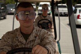 Marines from Headquarters and Support Battalion participate in an anti-drunk driving program called fatal vision during the InfoPalooza at the Marston Pavilion aboard Marine Corps Base Camp Lejeune, July 30. The program uses beer goggles to simulate up to .25 blood alcohol content.