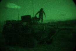 Sergeant Christopher Clifton, light armored vehicle crewman, Delta Company, 1st Light Armored Reconnaissance Battalion, prepares to execute a night maneuver during a weeklong field exercise here, Nov. 18 through 24, 2013. Clifton said night is the best time to attack because people tend to get tired, complacent and let their guard down.