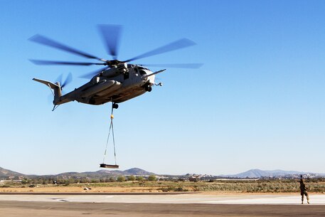 A CH-53E Super Stallion with Marine Heavy Helicopter Squadron 466, "Wolfpack," 3rd Marine Aircraft Wing, practices external lifts aboard Marine Corps Air Station Miramar, Calif., Feb. 28. The Super Stallion is toting a 6,200-pound load from a single-point sling, simulating external cargo transport as it would occur in areas of operation such as Afghanistan.