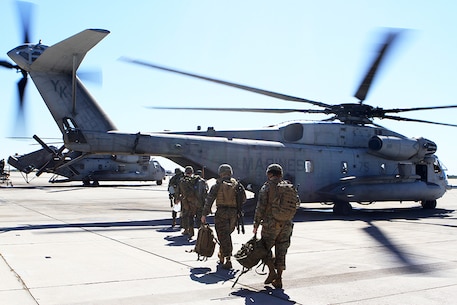 A helicopter support team prepares to board a CH-53E Super Stallion with Marine Heavy Helicopter Squadron 466, "Wolfpack," 3rd Marine Aircraft Wing, aboard Marine Corps Air Station Miramar, Calif. Feb. 28. The HST will coordinate and oversee the suspension of a load from the underside of the Super Stallion during external lift training.