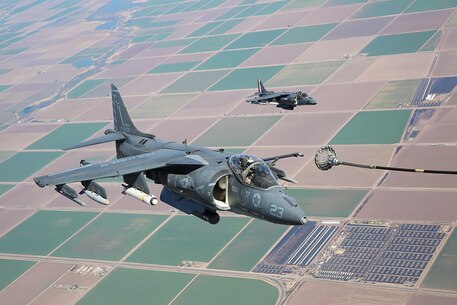 An AV-8B Harrier with Marine Attack Squadron 211, 3rd Marine Aircraft Wing, refuels during fixed-wing aerial refueling training over eastern California, Aug. 27. This training teaches pilots and air crew to refuel an aircraft without landing using a KC-130J Super Hercules, thus extending the operational capability of the aircraft during combat missions. (Photo by Lance Cpl. Michael Thorn)