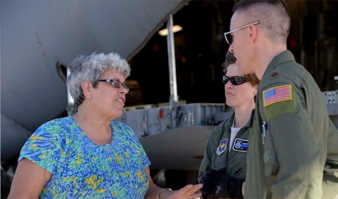 Kathy Cadden (left) meets with Maj. Jody Turk and Tech. Sgt. Penni Williams on Dec. 19, 2013, at Port-au-Prince, Haiti. Turk and Williams, along with other members assigned to the 97th Air Mobility Wing, supported a humanitarian aid delivery consisting of 136,000 pounds of rice, beans and corn meal, donated by Operation Ukraine, that will be distributed to various orphanages in Haiti. Cadden is the founder and president of Operation Ukraine, Turk is the assistant director of operations at the 730th Air Mobility Training Squadron and Williams is a 97th Security Forces Squadron mid-shift flight chief. (U.S. Air Force photo/Airman 1st Class Klynne Pearl Serrano)