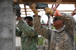 Singapore Army Cpl. 1st Class Guru Prasad, left, holds a frame support as U.S. Army Spc. Duy Khuc drills a hole into the support Feb. 2 during construction of a new building at Ban Hua Wang Krang School, Muang District, Phitsanulok province, Kingdom of Thailand. Four similar structures are being built throughout the Kingdom of Thailand during ongoing engineering civic assistance projects part of Exercise Cobra Gold 2013. Exercise Cobra Gold is the largest multinational exercise in the Asia-Pacific region and provides the Kingdom of Thailand, U.S., Singapore, Japan, Republic of Korea, Indonesia and Malaysia an opportunity to maintain relationships and enhance interoperability. Prasad is a combat engineer with Singapore Army Combat Engineers. Khuc is a construction engineer with the 643rd Engineer Company (Vertical), 84th Engineer Battalion, 130th Engineer Brigade, Schofield Barracks, Hawaii.