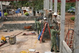 Singaporean and U.S. soldiers place support frames that will be cemented during construction of a new building at Ban Hua Wang Krang School, Muang District, Phitsanulok province, Kingdom of Thailand, Feb. 2. Four similar structures are being built throughout the Kingdom of Thailand during ongoing engineering civic assistance projects part of Exercise Cobra Gold 2013. Multinational involvement in CG 13 demonstrates commitment to building military-to-military interoperability with participating nations and to supporting peace and stability throughout the region. The Singaporean soldiers are with the Singapore Army Combat Engineers. U.S. service members are with the 643rd Engineer Company (Vertical), 84th Engineer Battalion, 130th Engineer Brigade, Schofield Barracks, Hawaii.