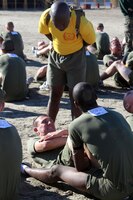 Sgt. Luckner L. Desma, drill instructor, Platoon 2169, Company H, 2nd Recruit Training Battallion, instructs a recruit to continue to push through his maximum set of crunches during his final physical fitness test aboard Marine Corps Recruit Depot San Diego Dec. 27. Recruits are required to perform as many crunches as they can in a time limit of two minutes. 
