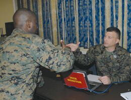Sgt. Irvin Stalls, left, license examiner, Fleet Support Division, Marine Corps Logistics Command, shakes hands with Master Sgt. Sean M. Weeks, motor transportation maintenance monitor, Headquarters Marine Corps, Quantico, Va., after completing his interview during a Headquarters Manpower Management Enlisted Assignment visit held at the Base Conference Center, Jan. 10.