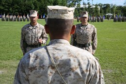 First Sgt. Monroe C. Boykin (left), the outgoing sergeant major 8th Engineer Support Battalion, 2nd Marine Logistics Group and Sgt. Maj. Russell A. Strack (right), the incoming battalion sergeant major, stand in front of Lt. Col. Ferdinand F. Llantero, the unit’s commanding officer, during a relief and appointment ceremony held aboard Camp Lejeune, N.C., July 11, 2013. Strack assumed the position of battalion sergeant major from Boykin, who served in the position for approximately three months.