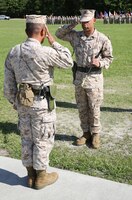 First Sgt. Monroe C. Boykin (right), the outgoing sergeant major 8th Engineer Support Battalion, 2nd Marine Logistics Group salutes Lt. Col. Ferdinand F. Llantero (left), during a relief and appointment ceremony held aboard Camp Lejeune, N.C., July 11, 2013. Boykin turned the battalion sergeant major’s Sword of Officer over to Sgt. Maj. Russell A. Strack. 