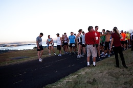 Competitors gather at the starting point of the Camp Smith 5K Grueler and wait for the horn to sound to release them onto the trails of the race route here July 20. The Grueler, a part of the Commanding Officer’s Fitness Series, was open to service members, their families and the general public.