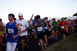 More than 150 service members, their families and other members of the community run in the Camp Smith 5K Grueler here July 20. The route, known for its scenic views and grueling ascent close 400 feet, also attracted many runners who were on Oahu for vacation. 