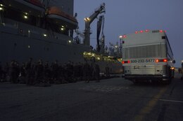Marines and Sailors assigned to Battalion Landing Team 3/2, 26th Marine Expeditionary Unit, arrive at Naval Station Norfolk, Va., March 10, 2013, in order to board the USS Kearsarge (LHD 3) for their deployment. The 26th MEU is deploying to the 5th Fleet and 6th Fleet areas of operation. The MEU operates continuously across the globe, providing the president and unified combatant commanders witha  a forward-deployed, sea-based, quick-reaction force. The MEU is a Marine Air-Ground Task Force capable of conducting amphibious operations, crisis-response and limited contigency operations.