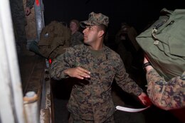 Cpl. Raul Carrilo Jr., a field radio operator assigned to Battalion Landing Team 3/2, 26th Marine Expeditionary Unit, arrives at Naval Station Norfolk, Va., March 10, 2013, in order to board the USS Kearsarge (LHD 3) for their deployment.  The 26th MEU is deploying to the 5th Fleet and 6th Fleet areas of operation. The MEU operates continuously across the globe, providing the president and unified combatant commanders witha  a forward-deployed, sea-based, quick-reaction force. The MEU is a Marine Air-Ground Task Force capable of conducting amphibious operations, crisis-response and limited contigency operations.