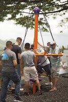 KAILUA, Hawaii — Marine, sailor and civilian volunteers help plant a huge component of the playground built at the YMCA Windward Branch, May 25. The playground was inspired by a group of children in the community. (U.S. Marine Corps photo taken by Lance Cpl. Matthew Bragg)