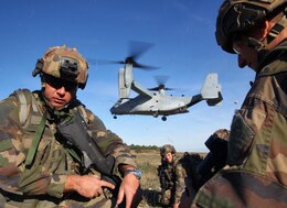 Legionnaires from the 2nd Foreign Infantry Regiment of France's 6th Light Armored Brigade hold their position while an MV-22B Osprey with Special-Purpose Marine Air-Ground Task Force Crisis Response takes off Oct. 30, 2013, at Camp des Garrigues, France. The event was part of a week-long bilateral training exercise between U.S. Marines with SP-MAGTF Crisis Response and French Legionnaires. The Osprey was the first of its kind to land on French soil as part of a military exercise. SP-MAGTF Crisis Response is a self-mobile, self-sustaining force capable of responding to a range of crises to protect both U.S. and partner-nation security interests in the region, as well as strengthening partnerships throughout the U.S. European Command and U.S. Africa Command area of responsibility. (U.S. Marine Corps photo by Cpl. Michael Petersheim)