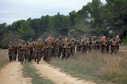 U.S. Marines with Special-Purpose Marine Air-Ground Task Force Crisis Response and Legionnaires with the 2nd Foreign Infantry Regiment of France's 6th Light Armored Brigade take part in a 7K obstacle course after conducting a heliborne raid Oct. 31, 2013, at Camp des Garrigues, France. The event was part of a week-long bilateral training exercise between U.S. Marines with SP-MAGTF Crisis Response and French Legionnaires. SP-MAGTF Crisis Response is a self-mobile, self-sustaining force capable of responding to a range of crises to protect both U.S. and partner-nation security interests in the region, as well as strengthening partnerships throughout the U.S. European Command and U.S. Africa Command area of responsibility. (U.S. Marine Corps photo by Cpl. Michael Petersheim)