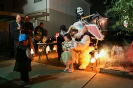 Mao Fuchikawa, 2, right, and Anji Nishimura, 3, approach a house decorated testing brave trick-or-treaters to collect candy aboard Marine Corps Air Station Iwakuni, Japan, during the Halloween Festival Oct. 31, 2013. Among the 302 visitors coming aboard station to partake in the Halloween festivities, 163 were children.