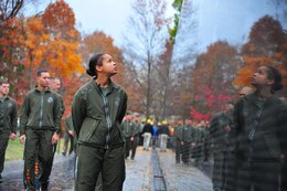 Gunnery Sgt. Nickea Redding, Advanced Course student at Quantico’s Staff Noncommissioned Officer Academy, reads the etched names of more than 58,000 Americans killed in the Vietnam War who are memorialized on the Vietnam War Memorial in Washington, D.C. Nov. 22, 2013. Quantico’s SNCO Academy, including students from Sergeants, Advanced, and Career courses, conducted a 7-mile Director’s Run that culminated their courses and honored the nation’s memorials and history. (Marine Corps photo by Lance Cpl. Cuong Le)