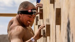 Spencer C. Garvin, a Marine with the 15th Marine Expeditionary Unit, completes the traversal wall obstacle during a Spartan Race in Las Vegas, April 5, 2014. Garvin, 26, is from Elko, Nev. (U.S. Marine Corps photo by Cpl. Emmanuel Ramos/Released)
