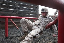 Corporal Jeffrey Samples, motor transport operator, Combat Logistics Battalion 5, Combat Logistics Regiment 1, 1st Marine Logistics Group, cautiously makes his way across an obstacle during the Leadership Reaction Course aboard Camp Pendleton, Calif., April 4, 2014. The course is designed to build leadership traits and further develop the bonds between Marines.