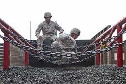 Corporal Jeffrey Samples, motor transport operator, Combat Logistics Battalion 5, Combat Logistics Regiment 1, 1st Marine Logistics Group, cautiously makes his way across an obstacle during the Leadership Reaction Course aboard Camp Pendleton, Calif., April 4, 2014. The course is designed to build leadership traits and further develop the bonds between Marines.