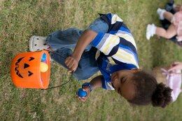 Julian Bryan, 4, picks up an Easter egg April 19 during an Easter egg hunt on Marine Corps Air Station Futenma. Family readiness officers with the air station organized the event for all status of force personnel and their families. The FROs separated the egg hunts by age group to keep it fair for all the children while Marine volunteers filled more than 1,100 eggs.