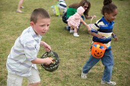 Jack Tetreault, 7, left, and Julian Bryan, 4, collect eggs April 19 during an Easter egg hunt on Marine Corps Air Station Futenma. Marine volunteers filled more than 1,100 Easter eggs and spread them out around the field. Family readiness officers with the air station organized the event. 