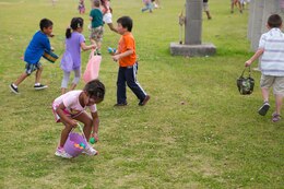 Olivia Hampton, 4, picks up an Easter egg April 19 during an Easter egg hunt on Marine Corps Air Station Futenma. The egg hunts were separated by age group to keep it fair for all the children. Family readiness officers with the air station organized the event while Marine volunteers filled more than 1,100 eggs. 